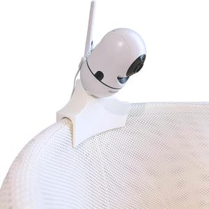 May include: A white baby monitor camera with a black lens and antenna is attached to a white mesh crib. The camera is mounted on a white bracket. The camera is designed for monitoring infants.