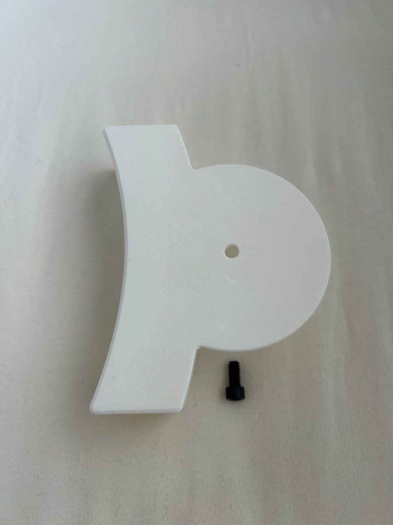 May include: White plastic 3D printed part with a round hole and a small black screw.