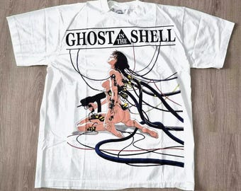May include: White t-shirt with a graphic print of a woman with wires connected to her body. The text "Ghost in the Shell" is printed above the image.