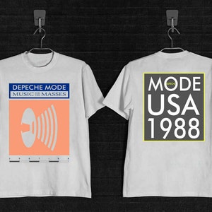 May include: White t-shirt with a black and white graphic print on the front that says "Depeche Mode Music for the Masses" and a black and white graphic print on the back that says "Mode USA 1988".