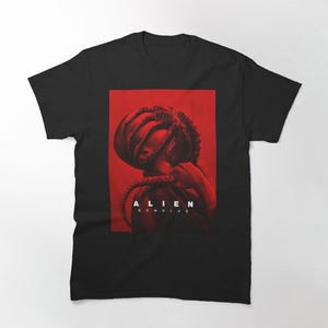 May include: Black t-shirt featuring a red graphic of a creature with the text "ALIEN ROMULUS" in white.