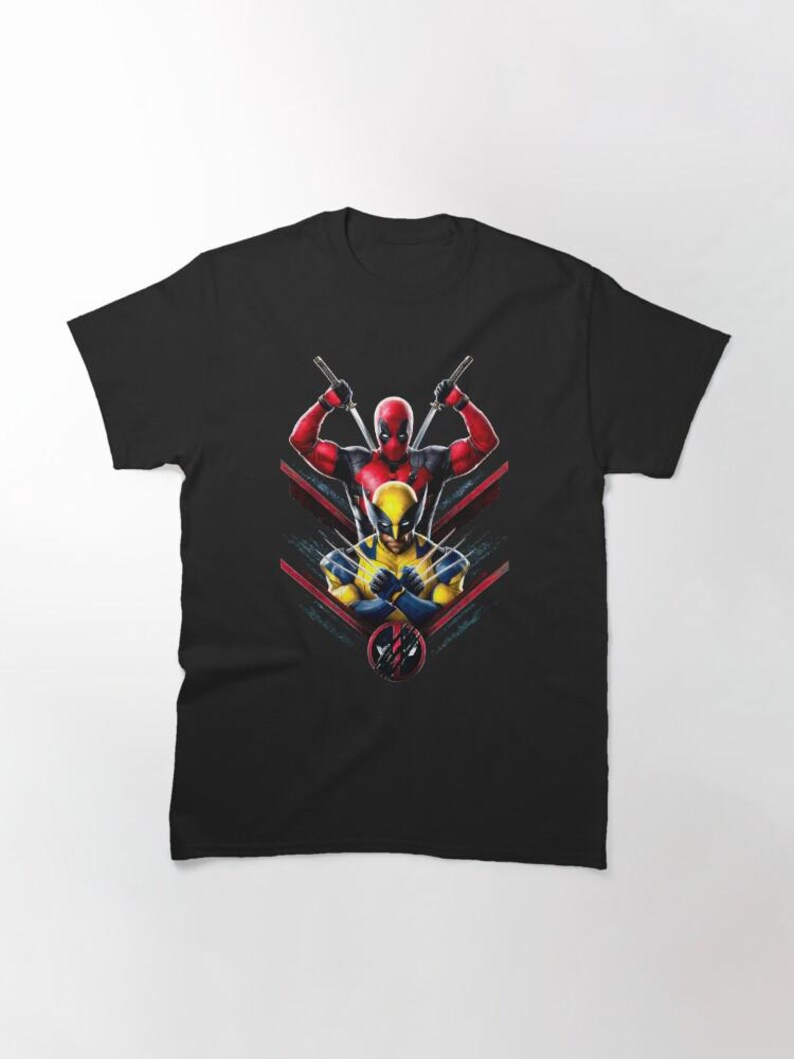 May include: Black t-shirt with a graphic of Deadpool and Wolverine fighting. The graphic is in a red, yellow, and black color scheme.