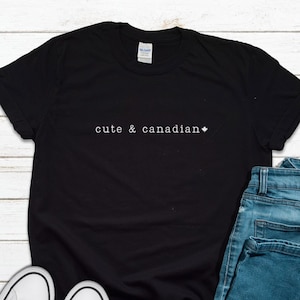 May include: Black t-shirt with the text "cute & canadian" and a small Canadian flag symbol.