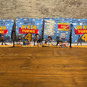 May include: Four blue and yellow party favor bags with the text "Welch's Ryker Turns 4" and a Toy Story theme. The bags feature characters from the movie, including Woody, Buzz Lightyear, and Jessie. One bag has the text "Thanks for coming!" and a QR code.