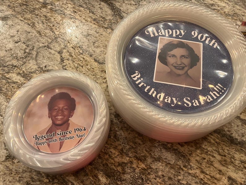 May include: Two round, clear plastic containers with lids. The smaller container features a photo of a person with the text 'Legend since 1964 Happy 60th Birthday Alan!'. The larger container shows a photo of a person with 'Happy 90th Birthday Sarah!!!'.