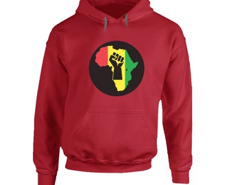 May include: Red hooded sweatshirt featuring a graphic of the African continent in red, yellow, and green, with a black fist in the center. The sweatshirt has a front pocket and a drawstring hood.