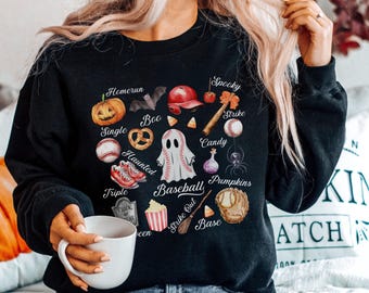 May include: Black sweatshirt with a Halloween baseball theme. The design includes a pumpkin, baseball, ghost, and other spooky elements. Text includes "Homerun", "Boo", "Haunted", "Spooky", "Strike", "Candy", "Baseball", "Pumpkins", "Strike Out", and "Base".