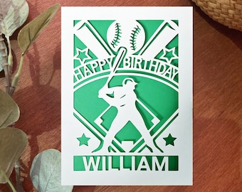 May include: A green and white baseball-themed birthday card with a silhouette of a baseball player, bats, and a baseball. The card says "Happy Birthday William".