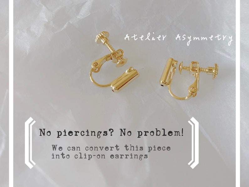 May include: A pair of gold clip-on earrings. The earrings are made of metal and have a simple design. The text "No piercings? No problem! We can convert this piece into clip-on earrings" is visible in the image.