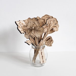 May include: A wooden bouquet of flowers in a clear glass vase with a tag that reads "Happy Mother's Day".