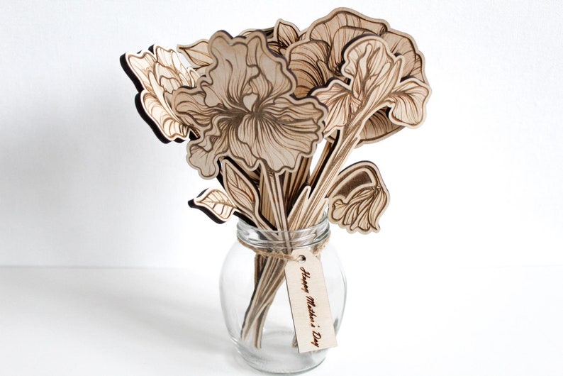 May include: A bouquet of laser-cut wooden flowers in a clear glass vase with a tag that reads "Happy Mother's Day".
