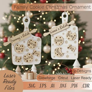 May include: Two wooden Family Cookie Christmas Ornaments hanging in front of a Christmas tree. Each ornament is shaped like a cutting board with cookie-shaped name tags and a rolling pin. The text "Family Cookie Christmas Ornament" is at the top.