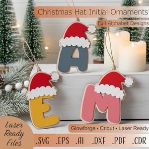 May include: Christmas Hat Initial Ornaments in red, white, and various colours. The ornaments feature letters of the alphabet, each topped with a Santa hat. The image includes the text "Laser Ready Files" and file type extensions.