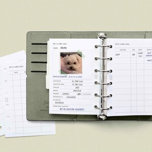 May include: A green leather binder with a white page open to a pet care log. The log includes a photo of a white dog, a section for pet information, and a section for vaccination records.