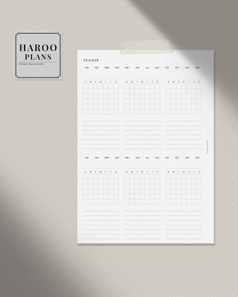 May include: A black and white printable planner insert with the text "HAROO PLANS" and "TRACKER". The planner insert has a monthly calendar layout with spaces for each day of the week.