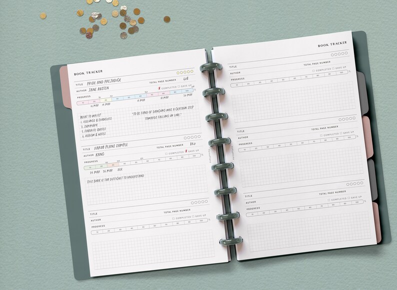 May include: A book tracker with a gray cover and pink tabs. The pages are white with black grid lines and text. The text includes "Book Tracker", "Pride and Prejudice", "Jane Austen", "Total Page Number", "Completed", "Give Up", "Read to Analyze", "To be sure of dancing well was a certain step towards feeling free in life", "Hard Plane Sample", "King", "Madsen", "Total Page Number", "Completed", "Give Up", "This book is the difficult to understand", "Title", "Author", "Progress", "Total Page Number", "Completed", "Give Up", "Title", "Author", "Progress", "Total Page Number", "Completed", "Give Up", "Title", "Author", "Progress", "Total Page Number", "Completed", "Give Up".