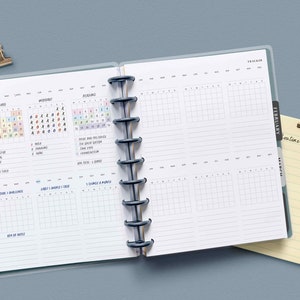May include: A monthly planner with a January and February tab. The planner has sections for mood, important, planning, and a daily tracker. The planner is open to show the January pages.