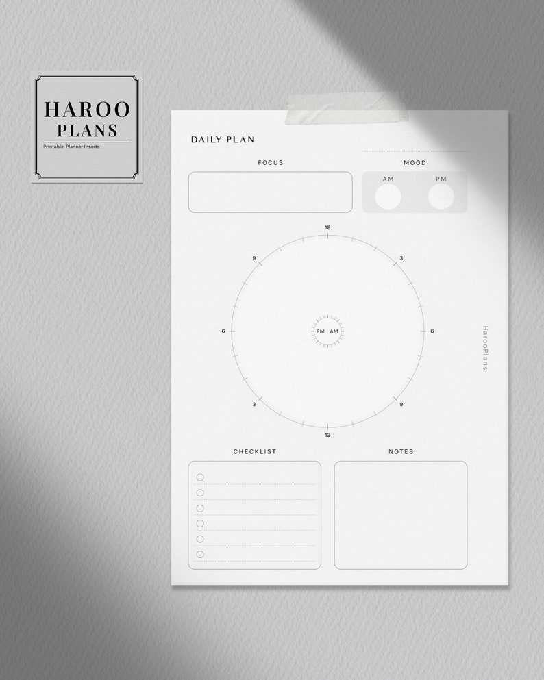 May include: A printable daily planner page with sections for focus, mood, checklist, and notes. The page also includes a circular time tracker with numbers 1 through 12 and the words "PM/AM" in the center.