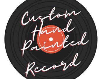 May include: A black vinyl record with concentric circles and a red label. The text "Custom Hand Painted Record" is written in white cursive on the record.