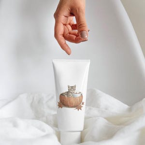 May include: White tube with a watercolor illustration of a gray tabby kitten in a pumpkin with a cup of coffee. The tube has the text "Watercolor Collection" and "Collection by Pati Paints".