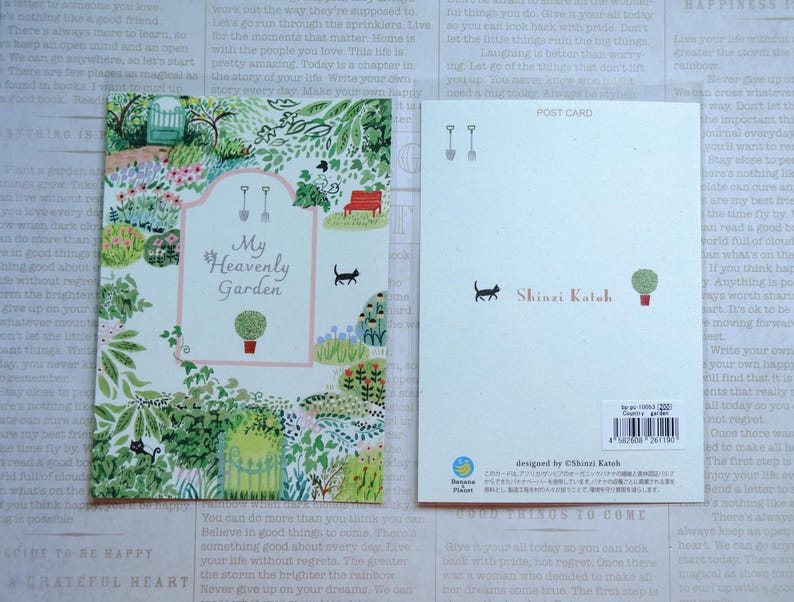 May include: A postcard featuring a colorful illustration of a garden with a pink sign that reads "My Heavenly Garden". The postcard is designed by Shinzi Katoh.