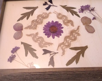 Pressed flower mandala painting in rustic green/grey frame. Organic design with florals and lacy jute. Makes a lovely housewarming gift.
