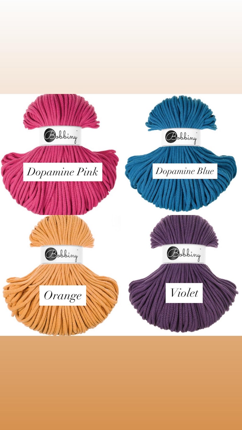 May include: Four skeins of Bobbiny cord arranged in a grid. The colors are Dopamine Pink, Dopamine Blue, Orange, and Violet. Each skein features a white paper label with the brand name Bobbiny and the specific color name printed in black text.