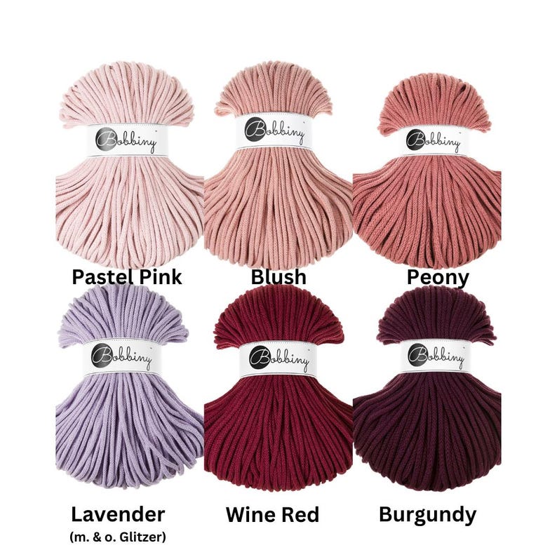 May include: Six skeins of Bobbiny cotton cord arranged in two rows. Colors include Pastel Pink, Blush, Peony, Lavender, Wine Red, and Burgundy. Each skein features a white paper band with the Bobbiny logo printed in black text.