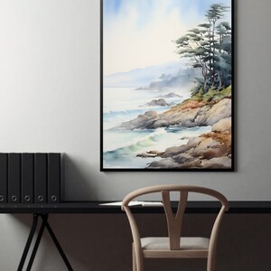 May include: A framed watercolor painting depicts a coastal landscape. The artwork features a rocky shoreline, ocean waves, and a cluster of trees. The color palette includes blues, greens, and browns, creating a serene and natural scene. The painting is displayed on a wall above a black desk.
