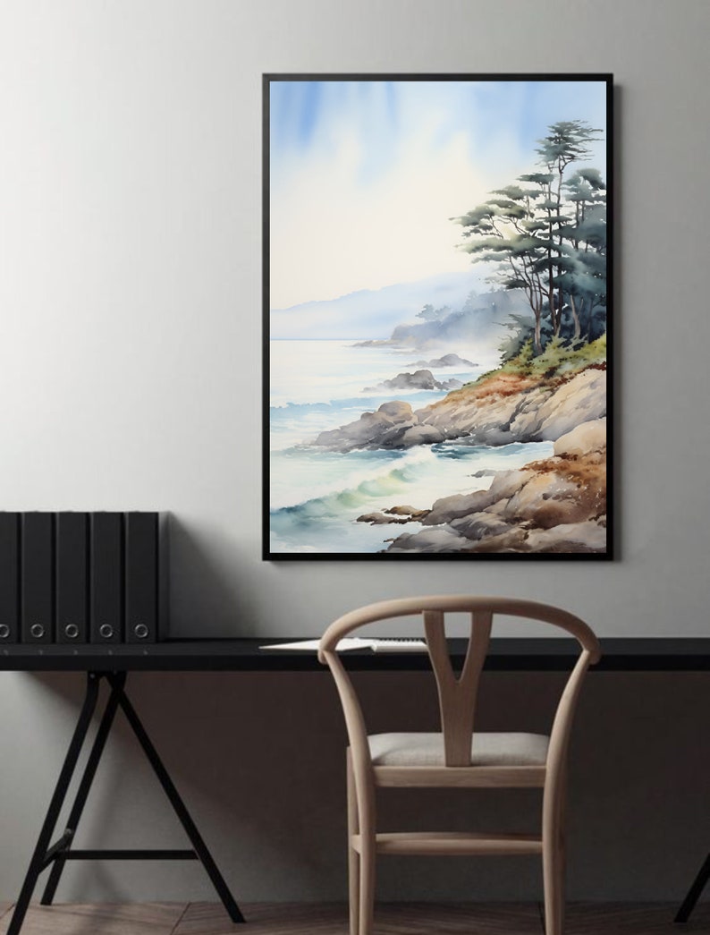 May include: A framed watercolor painting depicts a coastal landscape. The artwork features a rocky shoreline, ocean waves, and a cluster of trees. The color palette includes blues, greens, and browns, creating a serene and natural scene. The painting is displayed on a wall above a black desk.