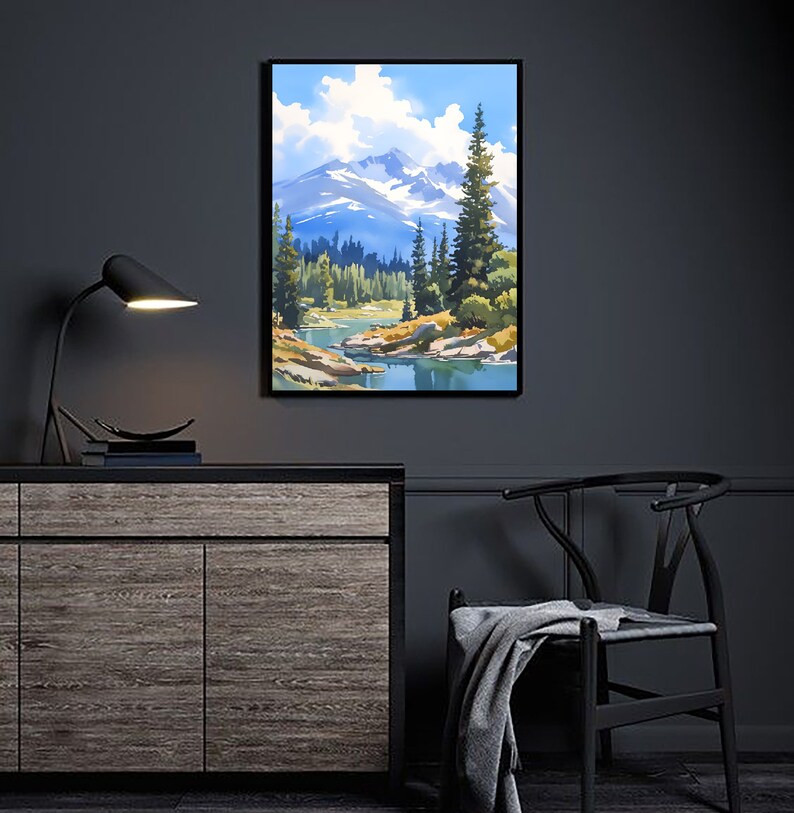 May include: A framed painting of a mountain landscape with a river flowing through it. The painting features a blue sky with white clouds, green trees, and a snow-capped mountain in the background.