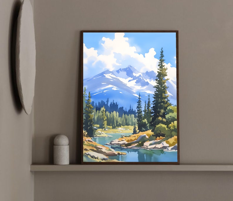 May include: A framed painting of a mountain landscape with a lake in the foreground. The mountains are snow-capped and the lake is surrounded by trees. The sky is blue with white clouds.