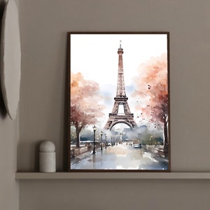 May include: A watercolor painting of the Eiffel Tower in Paris, France. The tower is depicted in the center of the image, with a street lined with trees and lampposts in the foreground. The sky is a light blue, and there are clouds in the distance.