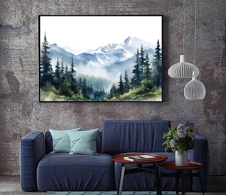 May include: A rectangular wall art print featuring a watercolour landscape of snow-capped mountains and a dense forest of pine trees in shades of blue, green, and white. The artwork is enclosed in a thin black frame and displayed on a textured wall.