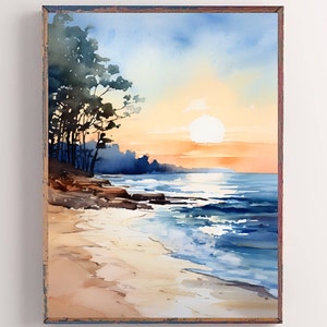 May include: Watercolor painting of a beach scene at sunset. The artwork features a vibrant sky with orange and blue hues, a bright sun, and the ocean. Dark trees and rocks are on the left, and the sandy beach is in the foreground. The painting is framed.