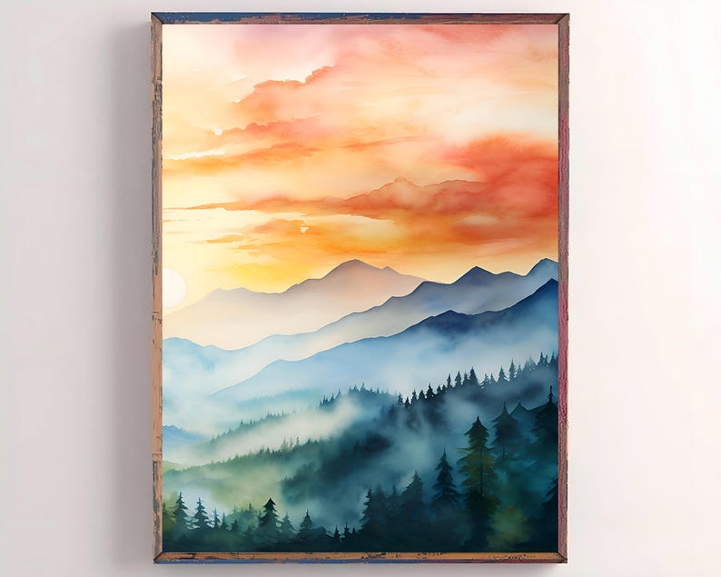 May include: Watercolor landscape art print featuring a mountain range under a vibrant sunset sky. The artwork showcases layers of blue mountains, misty valleys, and a colorful sky with shades of orange and yellow. The print is framed in a rustic wooden frame.