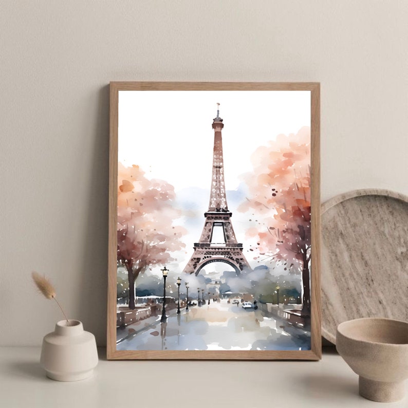 May include: A watercolor painting of the Eiffel Tower in Paris, France. The tower is depicted in the center of the image, with trees and a street in the foreground. The painting is done in shades of brown, gray, and white.