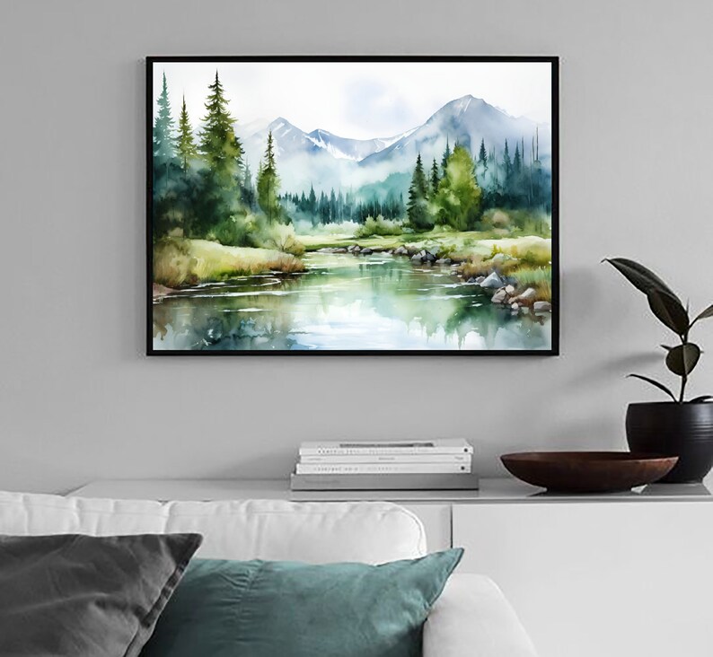 May include: A watercolor painting of a mountain landscape with a river flowing through a forest. The mountains are in the background, and the trees are in the foreground. The river is a light blue color, and the trees are a dark green color.