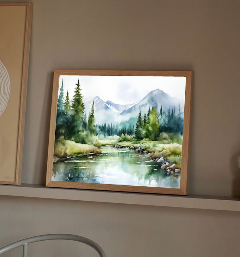 May include: Watercolor painting of a mountain landscape with a river flowing through it. The painting features a lush green forest with tall trees and a blue sky with white clouds. The mountains are in the background and are covered in a light blue haze.