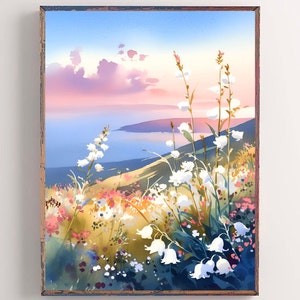 Pode incluir: Pintura em aquarela de uma paisagem costeira com flores brancas em primeiro plano. O fundo apresenta um mar azul, colinas e um c&eacute;u com tons rosa e azul. A obra de arte &eacute; emoldurada em uma moldura de madeira r&uacute;stica.