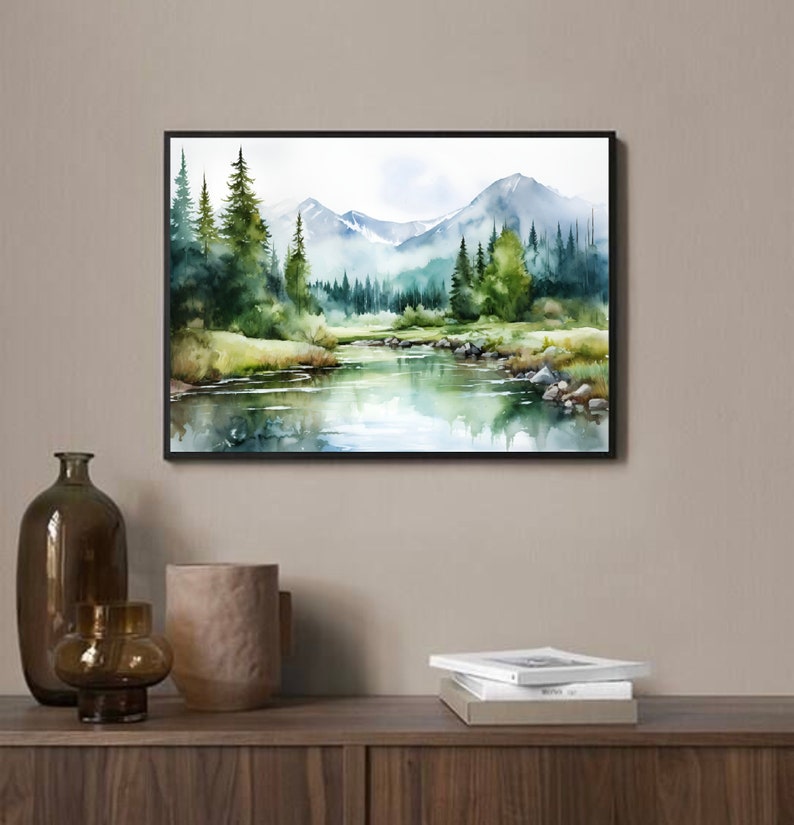 May include: Watercolor painting of a forest scene with a river flowing through it. The painting features a mountain range in the background, green trees, and a blue sky with white clouds.