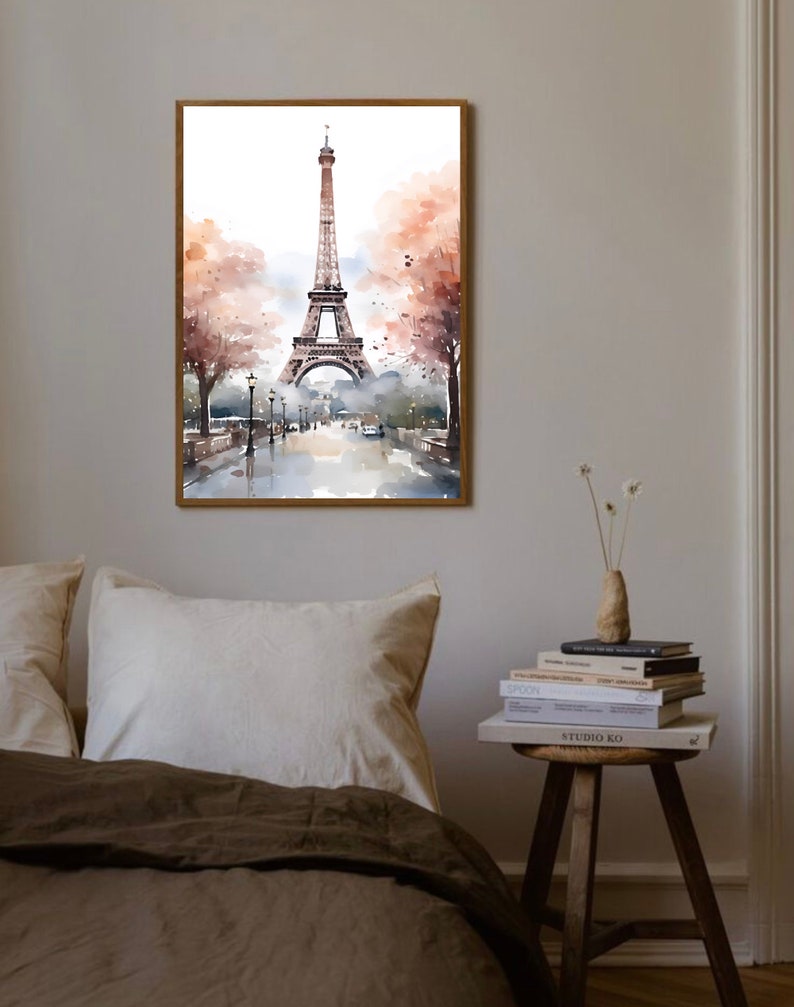 May include: A watercolor painting of the Eiffel Tower in Paris, France. The tower is depicted in the center of the image, with a street scene in the foreground. The painting is framed in a wooden frame.