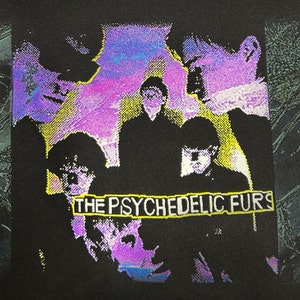 May include: A black t-shirt with a graphic print of a band called "The Psychedelic Furs". The band members are silhouetted against a purple and blue background.