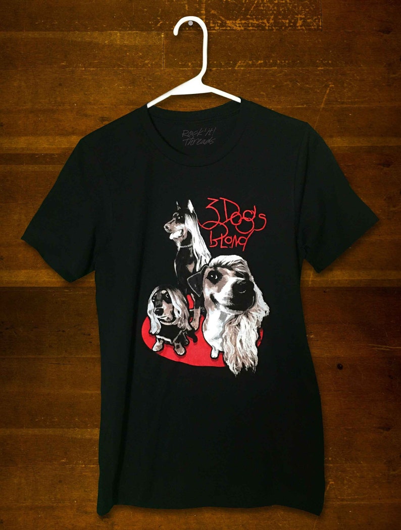 May include: Black t-shirt with a graphic of three dogs in a red heart. The text "3 Dogs Strong" is written in red above the dogs.