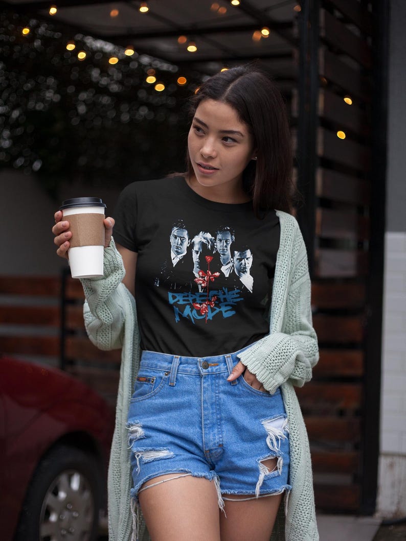 After a getting a coffee this asian girl leaves a coffee shop wearing her Depeche Mode t-shirt.