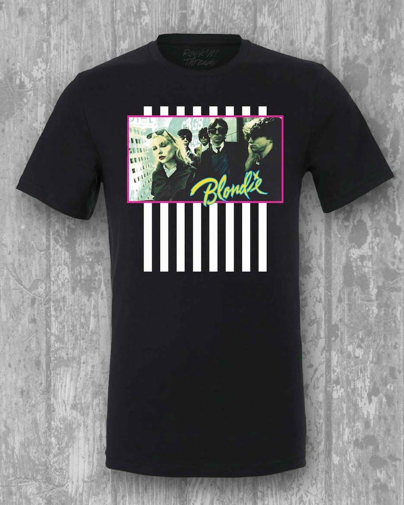 May include: Black t-shirt with a white and black striped design. The design features a photo of the band Blondie with the band name in green and yellow text.