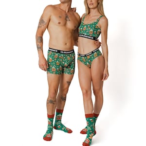 Puede incluir: Un par de ropa interior verde y blanca con un estampado de casa de jengibre. La ropa interior tiene la palabra "CloudIES" impresa en la cintura. La persona que lleva la ropa interior también lleva calcetines verdes y blancos con un estampado de casa de jengibre.