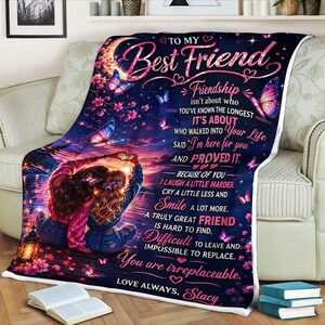 May include: A personalized throw blanket with a vibrant design. The blanket features a sunset scene with two figures, butterflies, and floral accents. Text includes "To My Best Friend" and a heartfelt message. The blanket is a cozy gift.