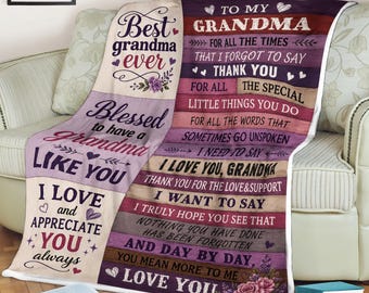 May include: A throw blanket featuring a cream-colored section with purple floral accents and the text Best grandma ever, and a multi-colored wood-plank patterned section with the text To my grandma for all the times that I forgot to say thank you.