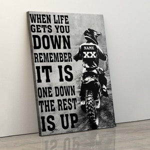 May include: Black and white motivational quote on a textured background with a silhouette of a motocross rider. The quote reads "When life gets you down remember it is one down the rest is up".